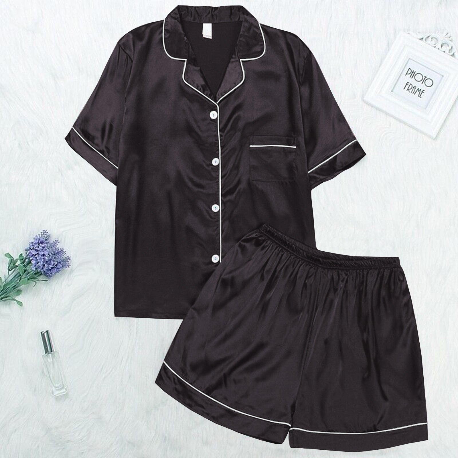 Schwarzer Satin-Pyjama-Set für Damen, kurzärmelig, mit Knopfleiste und weißen Paspeln.