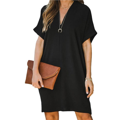 Frau in schwarzem Kleid mit brauner Clutch, lässiger Sommerlook, Modeaccessoires.