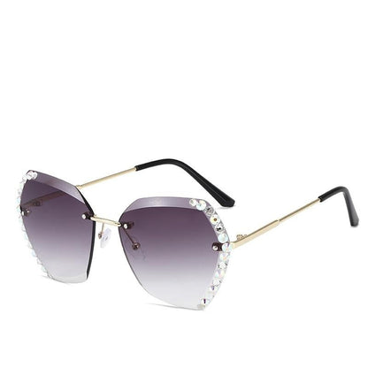 Damen Sonnenbrille mit Strass, sechseckig, lila Verlaufsgläser, goldene Bügel.