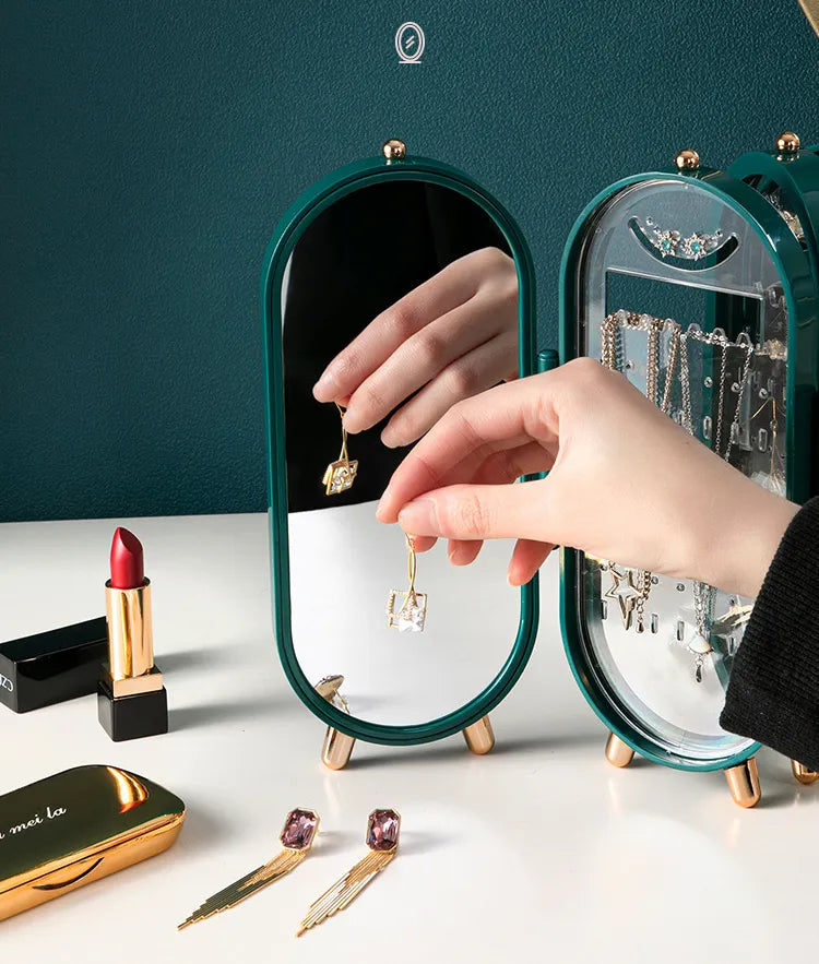 Grüner Schmuck-Organizer mit Spiegel, Ohrringe, Lippenstift, elegantes Design, Schmuckaufbewahrung.