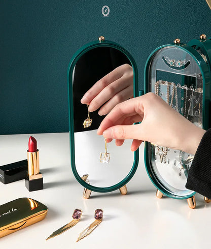Grüner Schmuck-Organizer mit Spiegel, Ohrringe, Lippenstift, elegantes Design, Schmuckaufbewahrung.