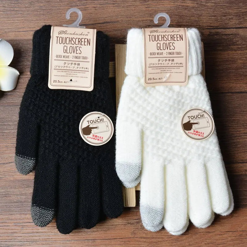 Schwarze und weiße Touchscreen-Handschuhe aus Strick, ideal für Smartphones.