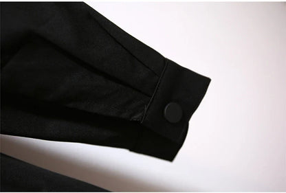 Schwarzer Ärmel mit Knopf, elegantes Design, hochwertige Stoffe, modische Kleidung.