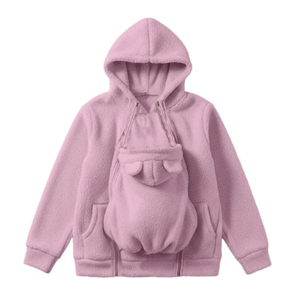 Rosa hoodie i sherpafleece uppställd platt, med den avtagbara babypanelen med björnöron öppen framtill och dragkedjor längs sidorna. 1