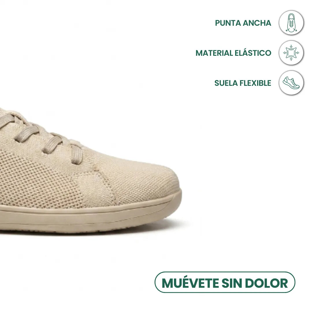Närbild på tådelen av den beige skon med ikoner för bred tå, elastiskt material och flexibel sula. 5