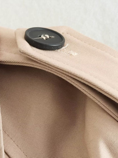 Beiger Trenchcoat-Kragen mit schwarzem Knopf, elegantes Design, hochwertige Verarbeitung.