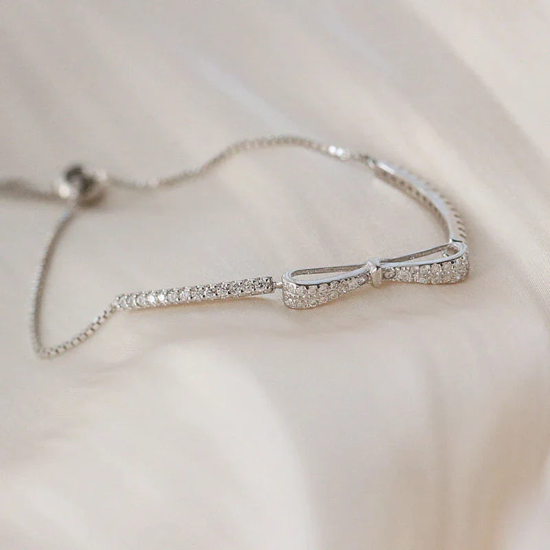Silbernes Armband mit Schleifen-Design, funkelnde Kristalle, eleganter Schmuck für Damen.