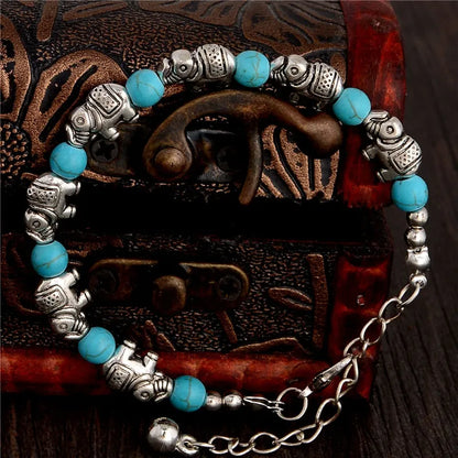 Silberarmband mit blauen Perlen und Elefantenanhängern, handgefertigt, Boho-Stil.