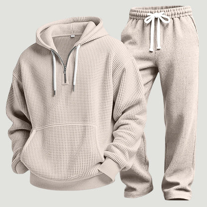Beige set av våffelstickad huvtröja med halv dragkedja och joggingbyxor med vitt dragsnöre, fristående produktbild. 8