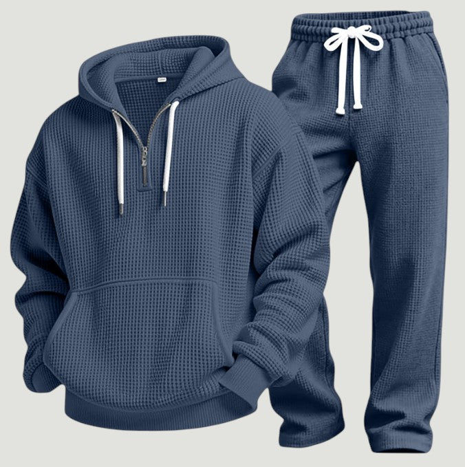 Blågrått set av våffelstickad huvtröja med halv dragkedja och matchande joggingbyxor med vita dragsnören, fristående produktbild. 9