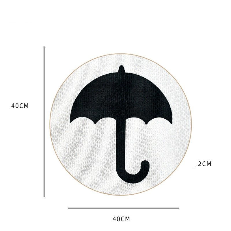 Runder Teppich mit schwarzem Regenschirm-Motiv, 40cm Durchmesser, 2cm dick, weißer Hintergrund.