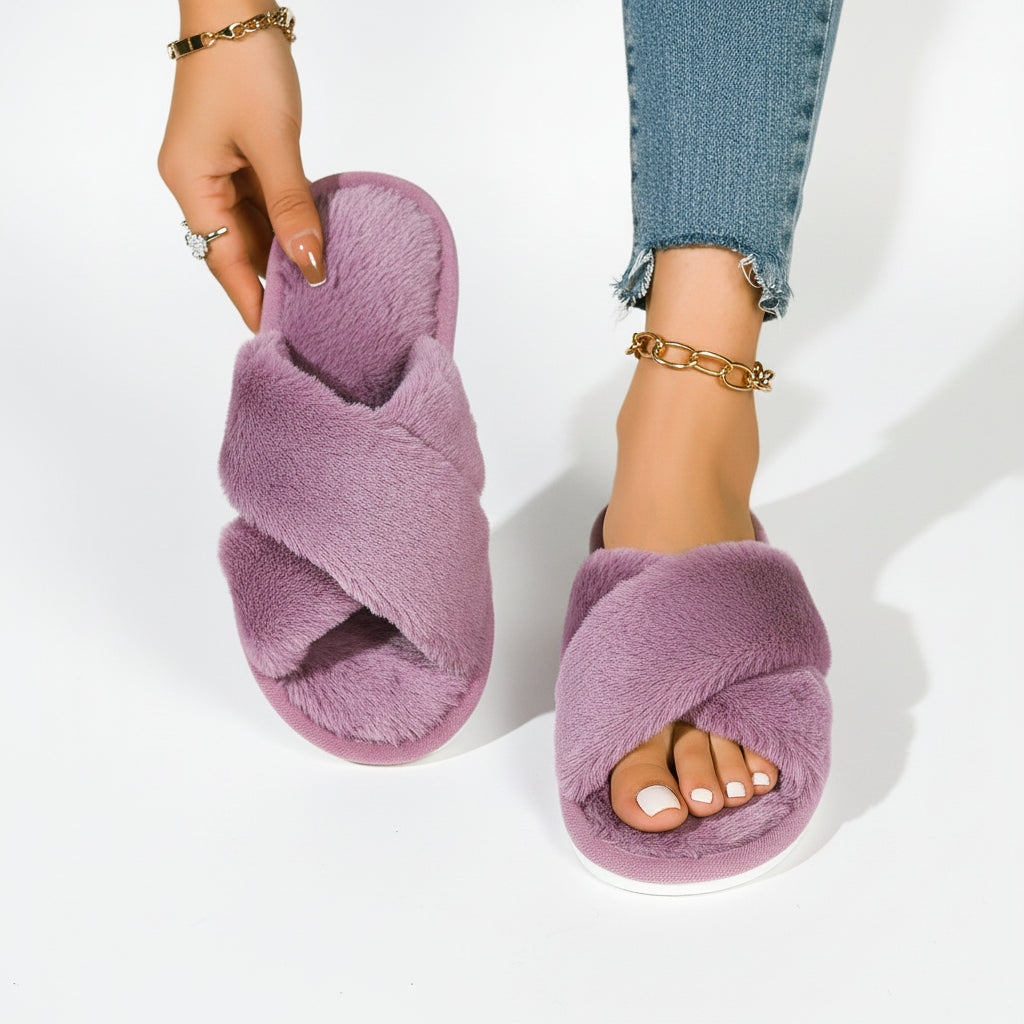Lila plyschiga innesandaler med korsade remmar, den ena hållen i handen och den andra buren med jeans och guldarmband. 8