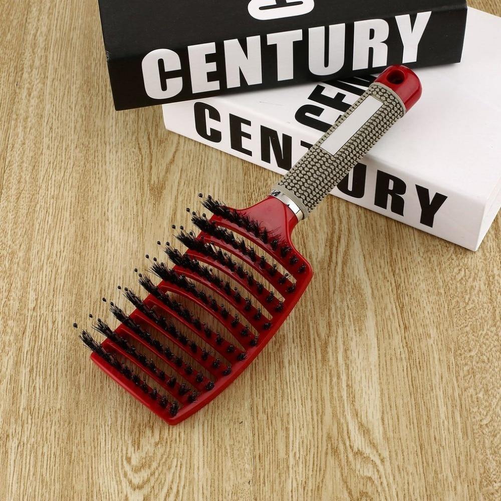 Rote Haarbürste mit ergonomischem Griff auf Holztisch, ideal für Styling und Entwirren.