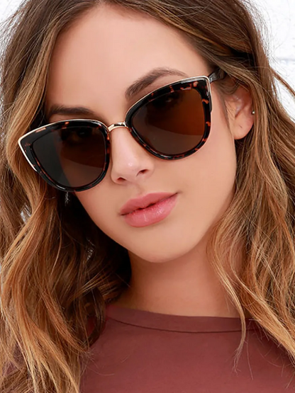 Frau mit Retro-Cat-Eye-Sonnenbrille, braun getönt, Schildpattmuster, modisch, stilvoll.
