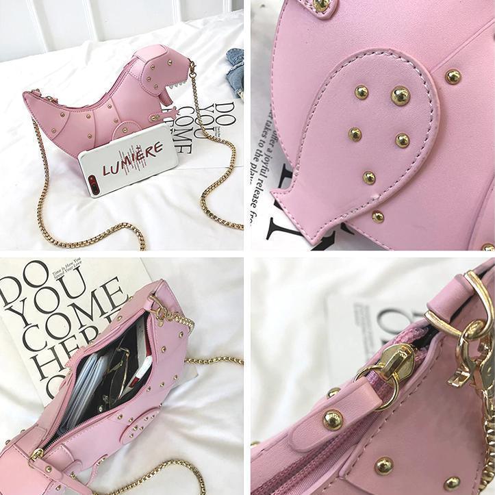 Rosa Mini-Tasche in Dinosaurierform mit goldenen Nieten und Kettengurt, modisches Accessoire.