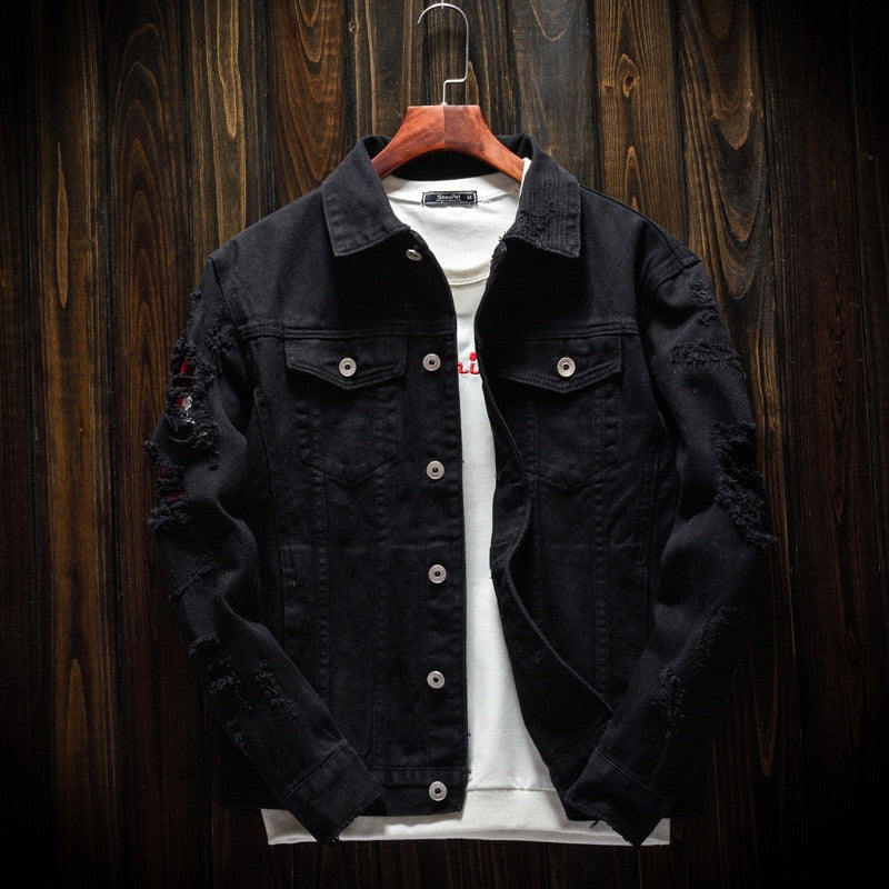 Schwarze Jeansjacke Herren, zerrissen, Knopfleiste, Holzkleiderbügel, modisch, lässig.