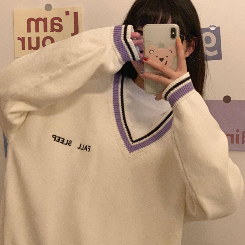 Frau in cremefarbenem Pullover mit V-Ausschnitt und lila Streifen, Selfie, modisch, lässig.