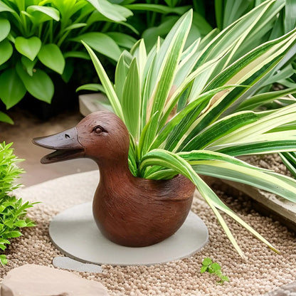 Entenförmiger Blumentopf aus Keramik mit grüner Pflanze, Gartendekoration, modern, stilvoll.