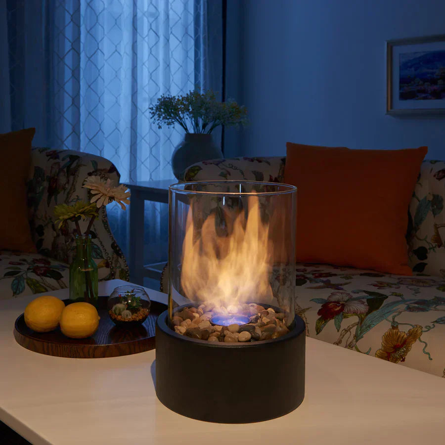 Tischkamin Glaszylinder mit Flammen, Dekosteine, modernes Wohnzimmer, stimmungsvolle Beleuchtung
