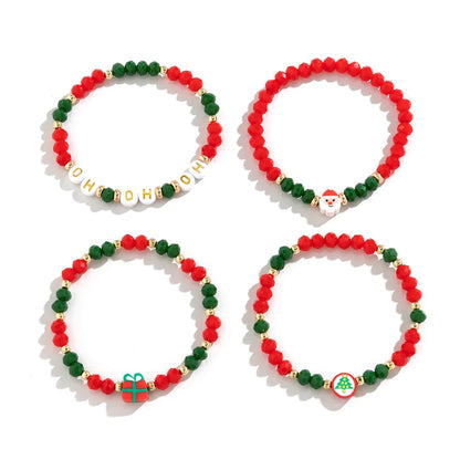 Vier bunte Weihnachtsarmbänder mit Perlen, Rot-Grün, mit Santa- und Geschenk-Designs.