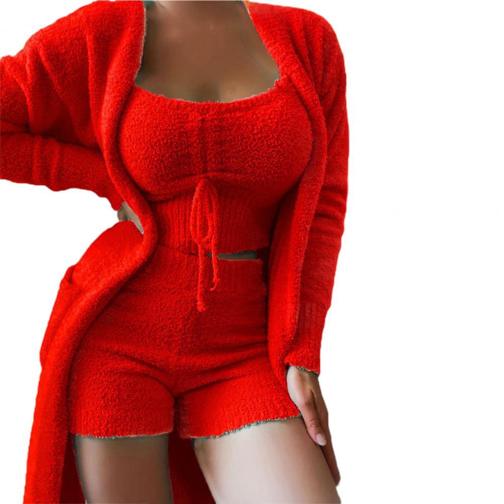 Frau in rotem Strick-Set: Cardigan, Top, Shorts. Modetrend, bequeme Damenbekleidung.