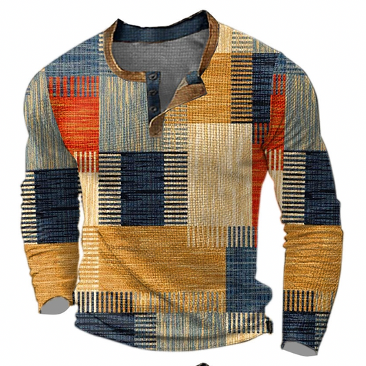 Långärmad tröja med knappslå och geometriskt rutmönster i orange, mustard, marinblått och beige, sedd framifrån mot vit bakgrund. 1
