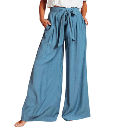 Frau in blauer, weiter Hose mit Bindegürtel, lässiger Sommerlook, Mode für Damen.