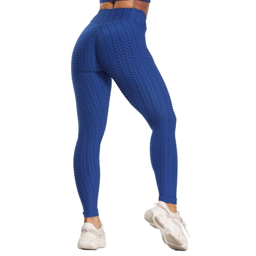 Frau in blauer Sportleggings, nahtlos, hoch tailliert, mit weißen Turnschuhen.