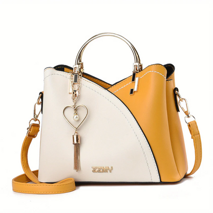 Gelbe und weiße Damenhandtasche aus Leder mit Herzanhänger, modisch, elegant, Umhängetasche.