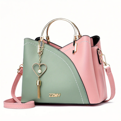 Damenhandtasche rosa-grün, Leder, goldener Henkel, Herzanhänger, modisch, elegant.