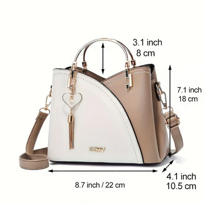 Damenhandtasche zweifarbig, Leder, beige-weiß, mit Herzanhänger, verstellbarer Schulterriemen.