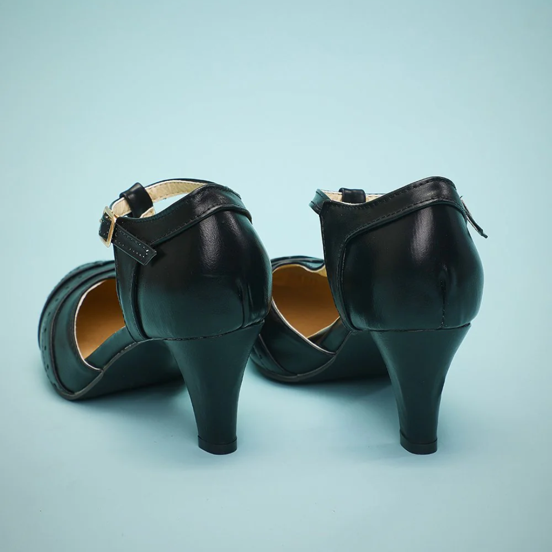 Schwarze Damenpumps aus Leder mit Riemen, mittlerer Absatz, elegantes Design.