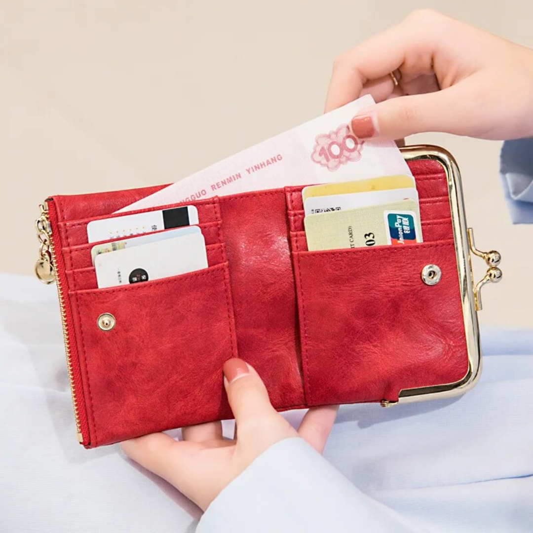 Rote Vintage-Kisslock-Geldbörse aus Leder, kompakt, mit Kartenfächern und Münzfach.