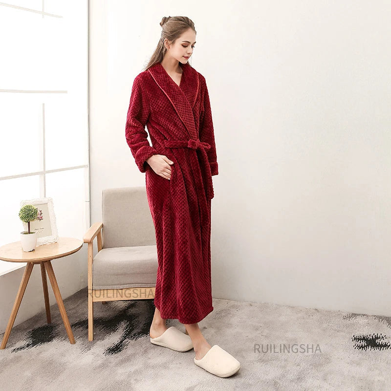 Frau im weinroten Fleece-Bademantel, gemütlich, warm, mit Gürtel, in modernem Wohnzimmer.