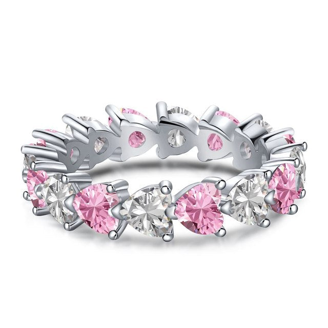 Silberring mit rosa Saphiren, Herzform, Ehering, elegantes Schmuckdesign, Damenmode.