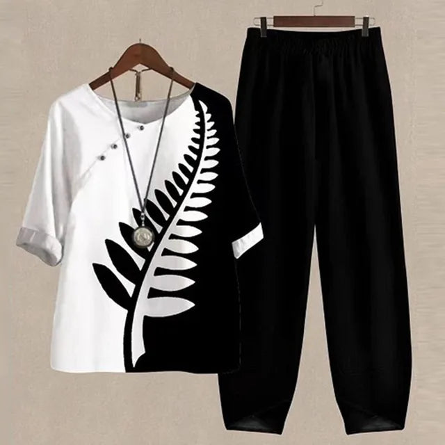 Zweiteiliges Damen-Set, schwarz-weiß, florales Shirt, hohe Taille Hose, Sommermode.