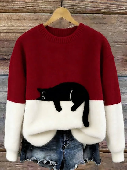 Luddig tröja i vinrött och vitt med svart katt, på galge med jeansshorts nedanför 6