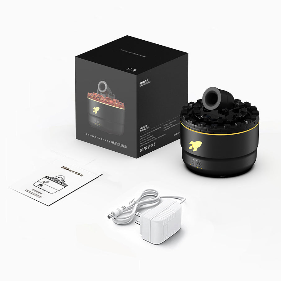 Schwarzer Aroma-Diffuser mit Verpackung, USB-Kabel und Anleitung auf weißem Hintergrund.