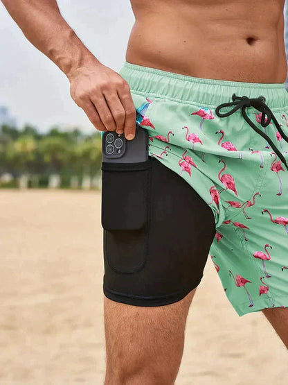 Männer-Badeshorts mit Flamingo-Print, grün, Handyfach, Strandmode, Sommerbekleidung.