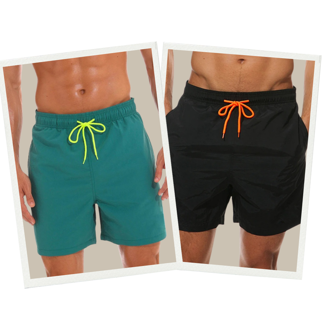 Zwei Herren-Badeshorts, grün mit gelbem Band, schwarz mit orangefarbenem Band, Sommermode.