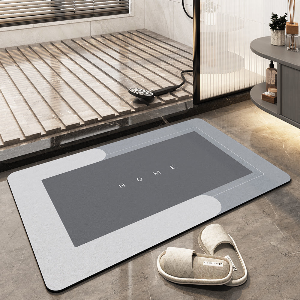 Graue Badematte mit "HOME"-Aufdruck, rutschfest, saugfähig, Badezimmer, moderne Einrichtung.