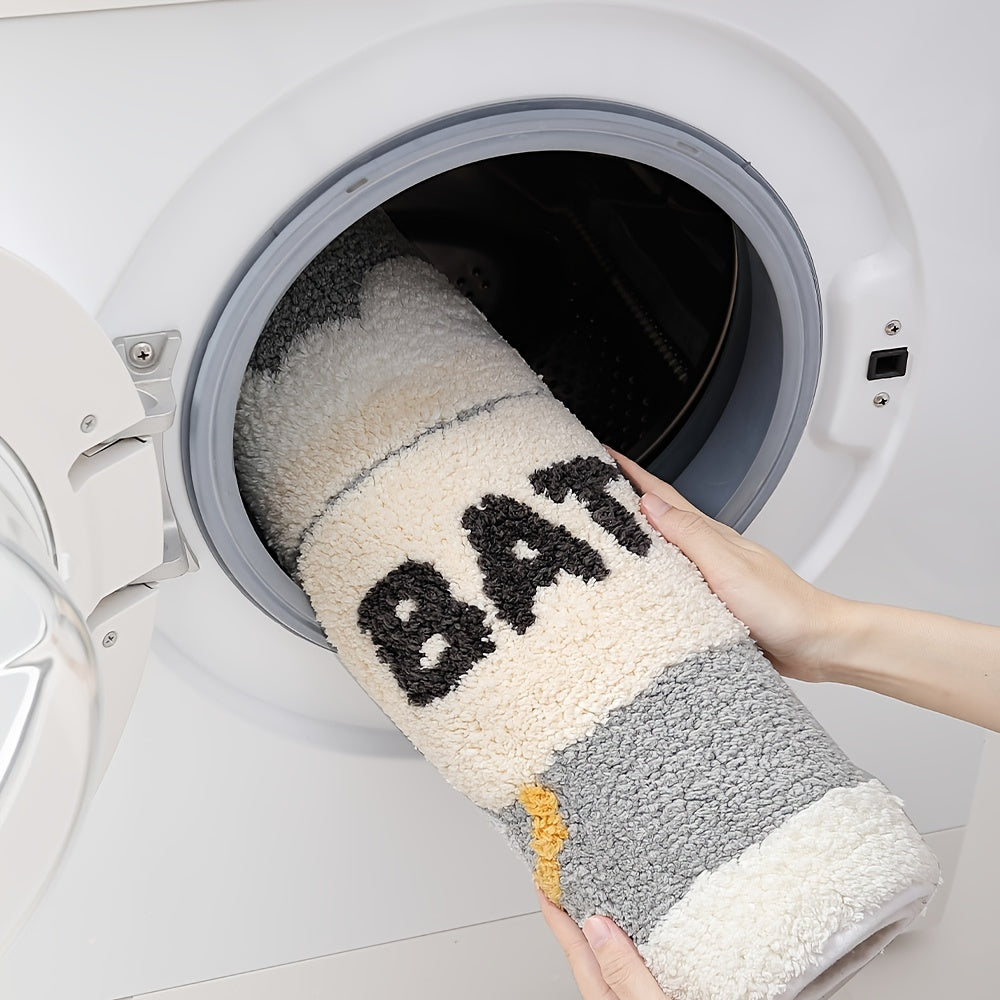 Waschmaschinenfester Badematte, grau-weiß, flauschig, mit Schriftzug, einfache Reinigung.