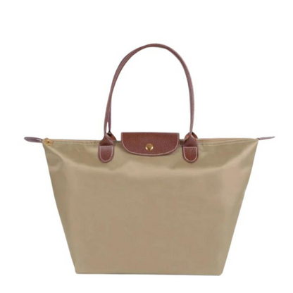 Beige Damenhandtasche aus Nylon mit braunen Ledergriffen, stilvoll und geräumig.