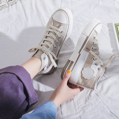 Beige High-Top-Sneaker aus Segeltuch, Damenmode, lässiger Stil, Schnürschuhe, auf weißem Hintergrund.