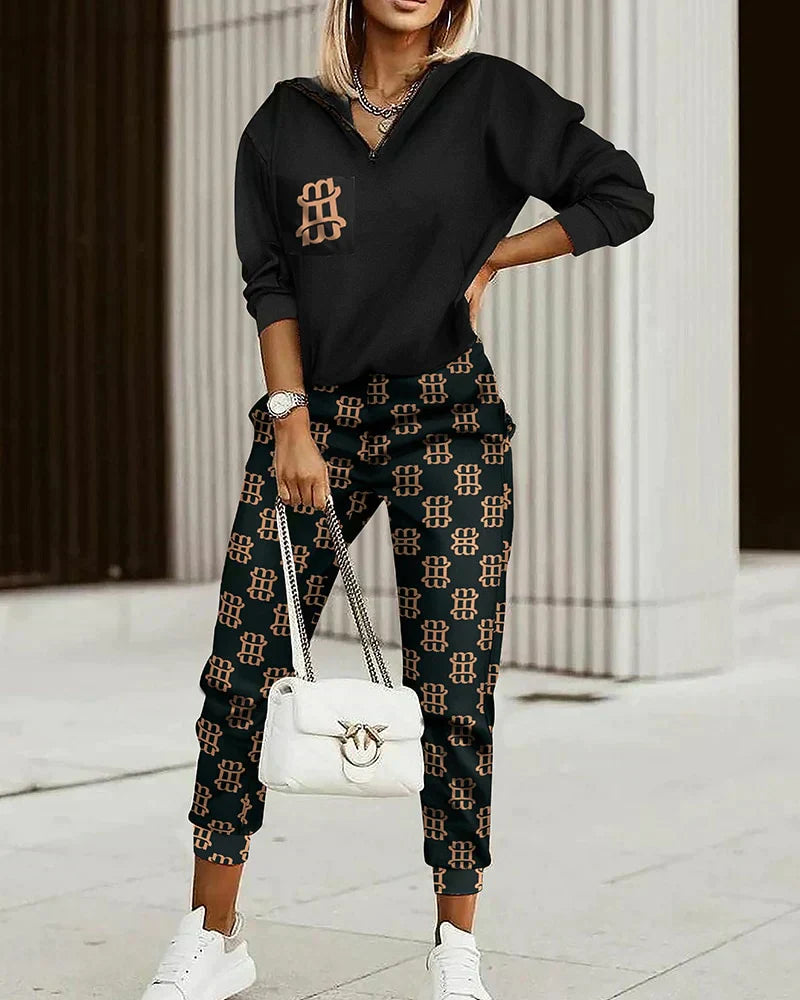 Frau in schwarzem und braunem Designer-Trainingsanzug mit Tasche, modern und bequem.