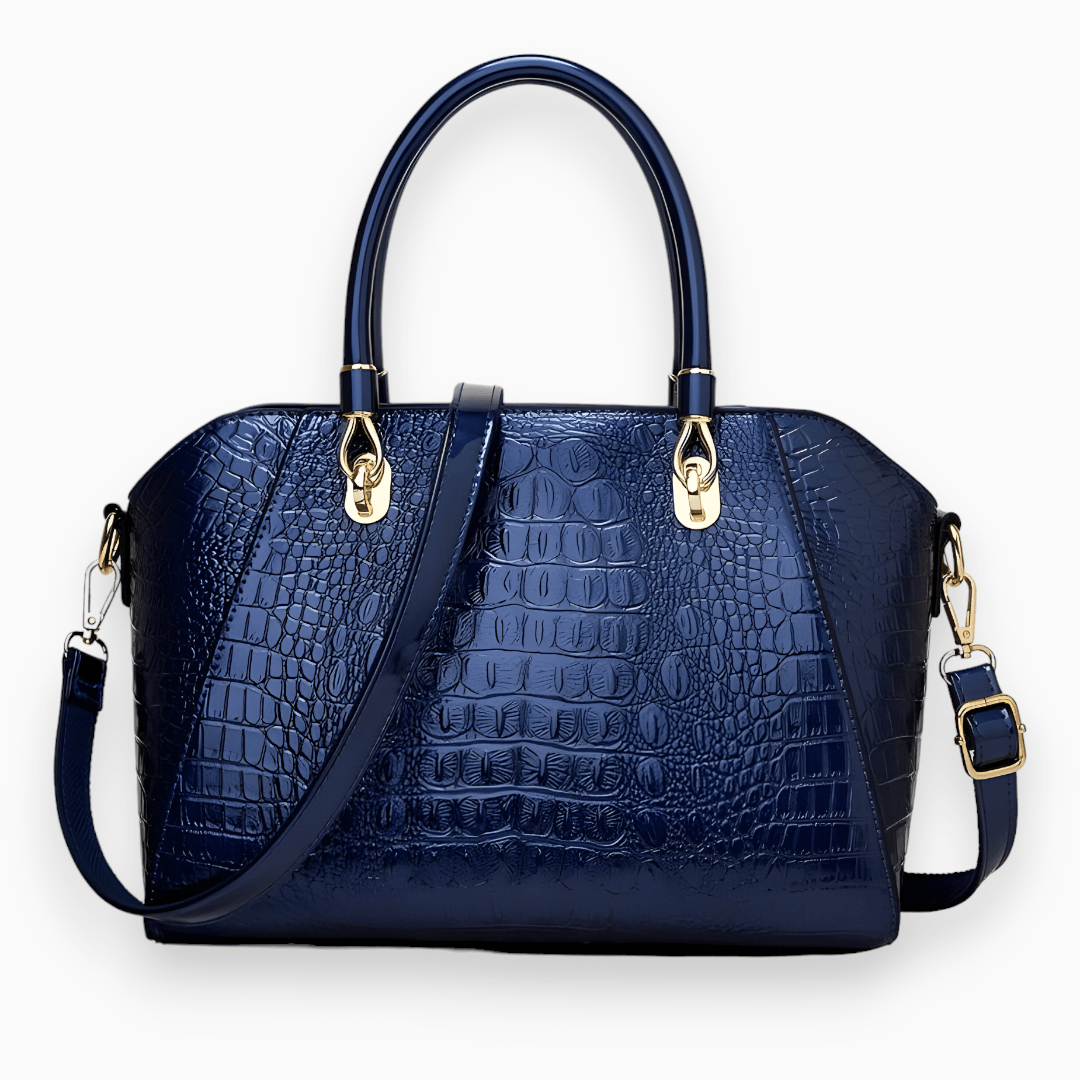 Dunkelblaue Krokodilleder-Handtasche mit goldenen Beschlägen und abnehmbarem Schulterriemen.