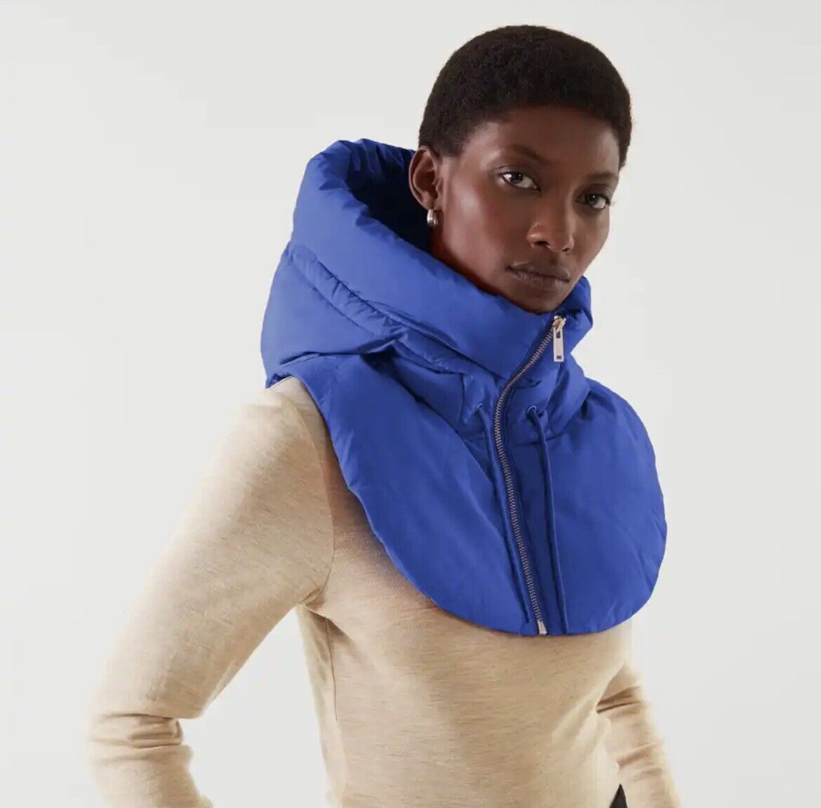 Frau trägt blauen Kapuzenschal, modisches Accessoire, Wintermode, Reißverschluss, elegant.