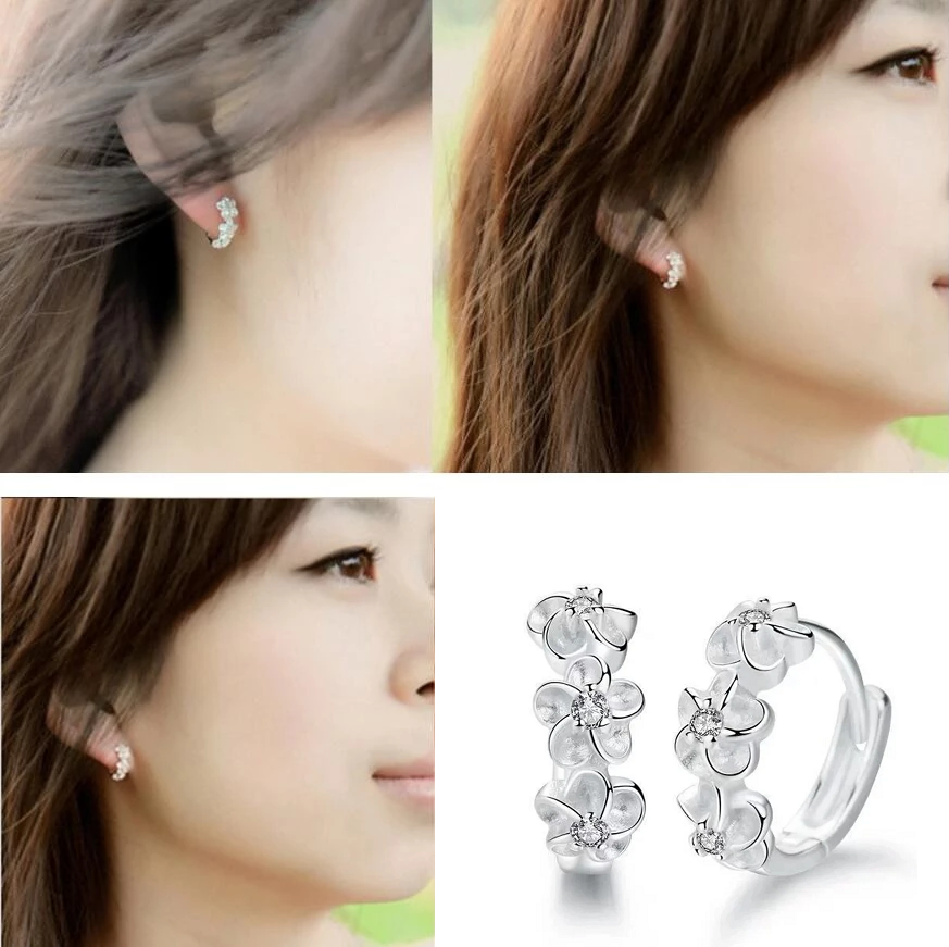 Silberne Blumen-Ohrringe mit Kristallen, eleganter Schmuck für Damen, modisches Accessoire.
