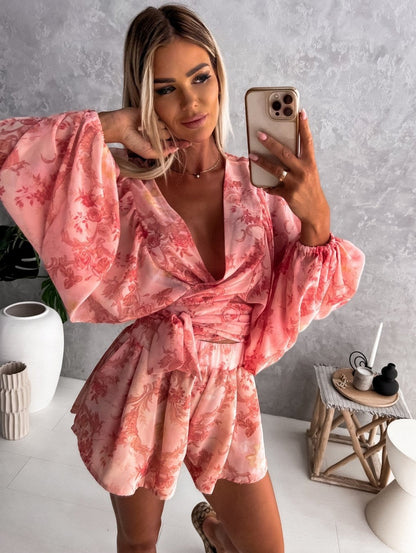 Frau in rosa geblümtem Kleid macht Selfie, modisches Sommeroutfit, elegante Kleidung.