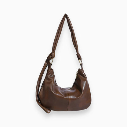 Braune Lederhandtasche mit Schulterriemen, modisches Accessoire, Damenmode, elegant.